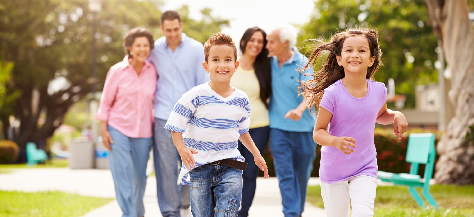 Kids Running with Extended Family behind them