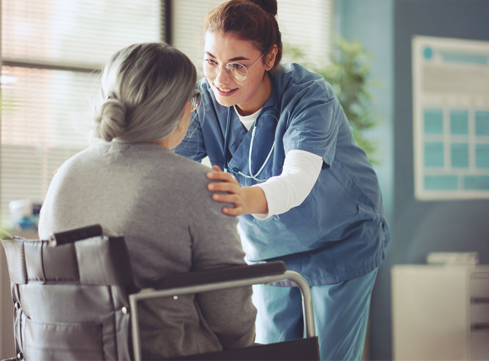 Nurse Talking to a patient in a wheelchair Nurse Talking to a patient in a wheelchair