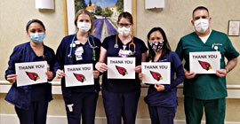 Nurses holding thank you signs